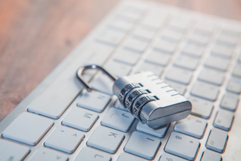 Candado de combinación sobre el teclado de un ordenador, seguridad y antivirus